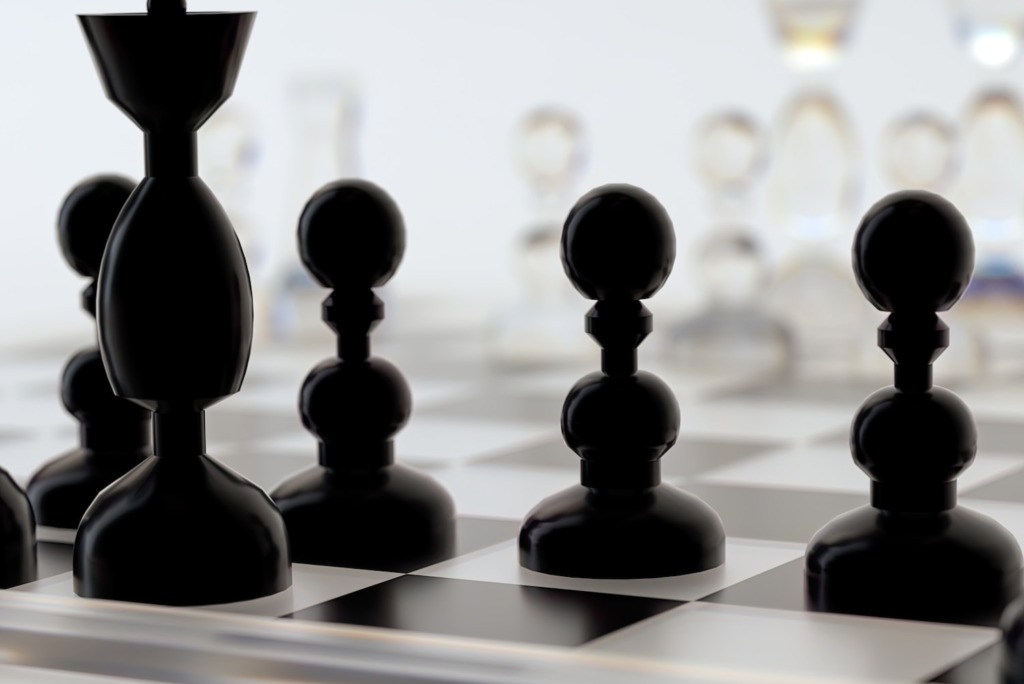 a close up of a chess board with pieces on it