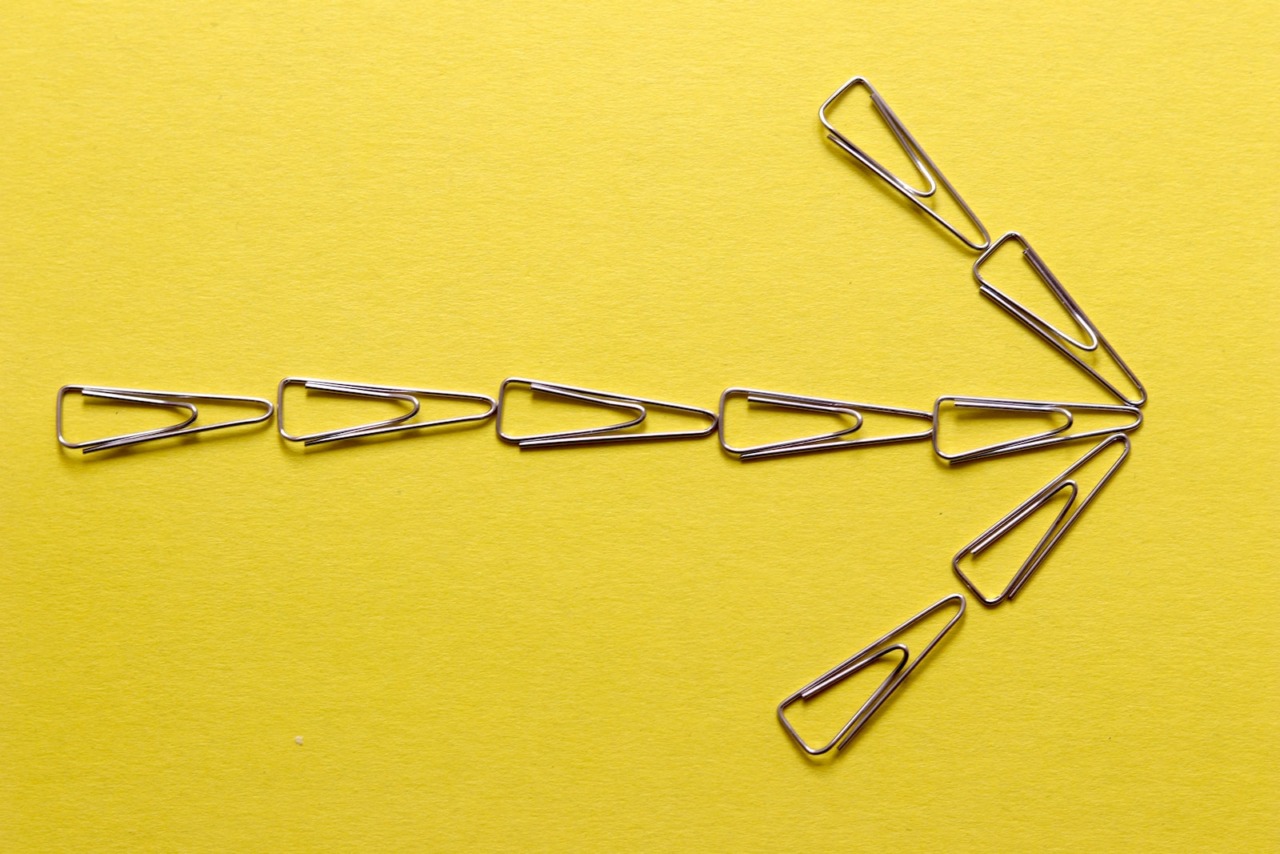 silver paper clip on yellow textile