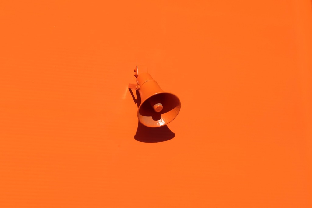 orange megaphone on orange wall