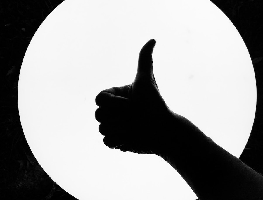 persons hand on white round board