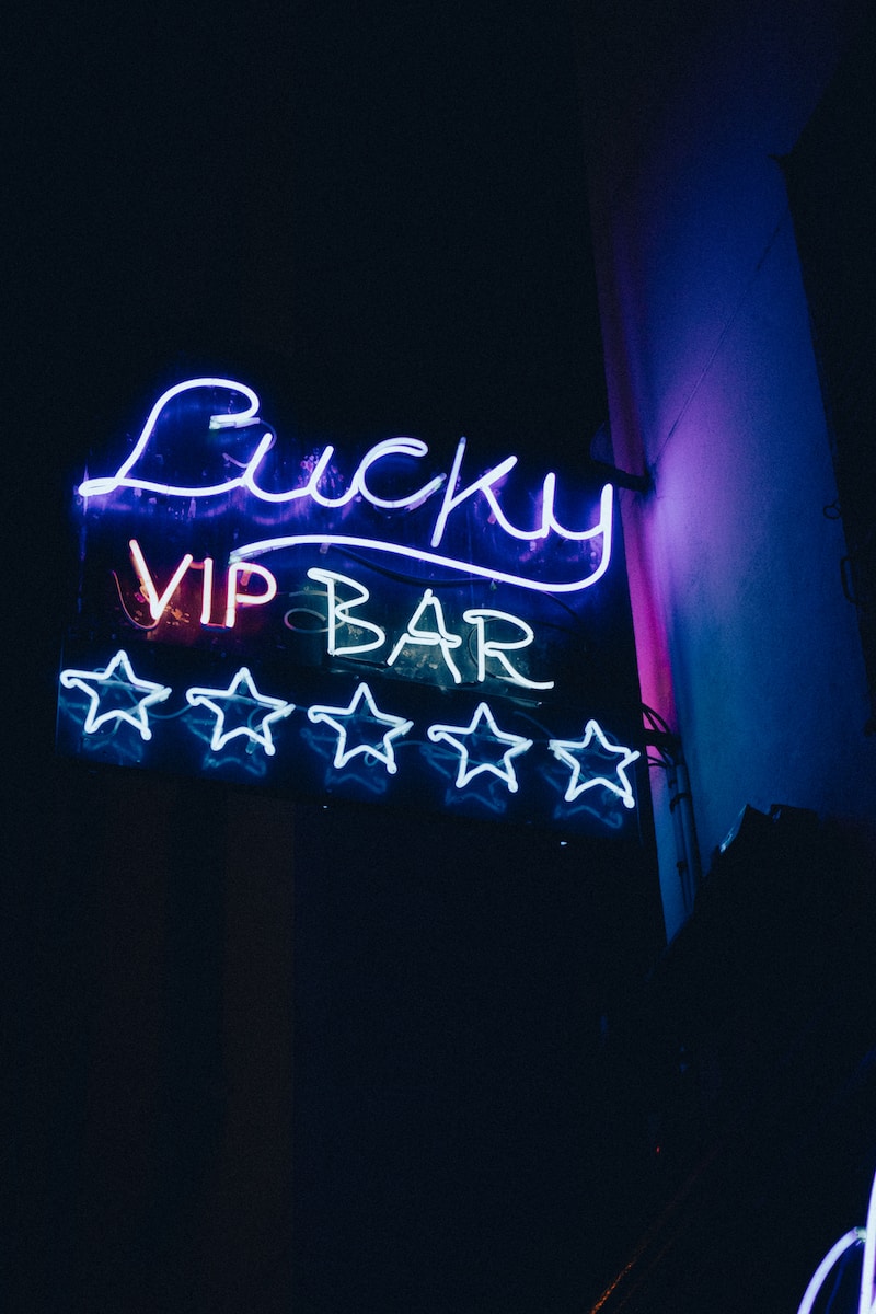 a neon sign that says lucky vip bar