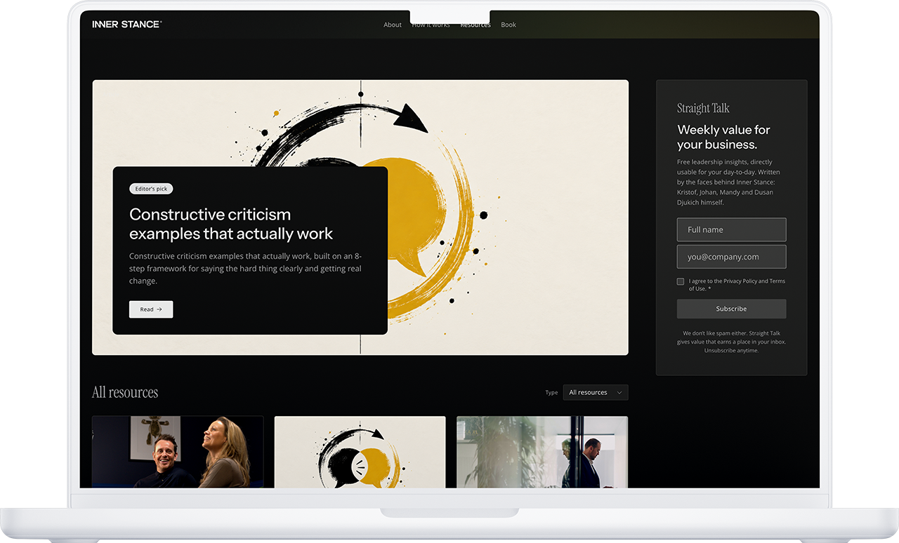 Op een laptop is een website te zien met een donker thema, abstracte kunst en een pop-up over opbouwende kritiek, waarin het belang wordt benadrukt van het ontwikkelen van een innerlijke houding die openstaat voor groei en feedback.