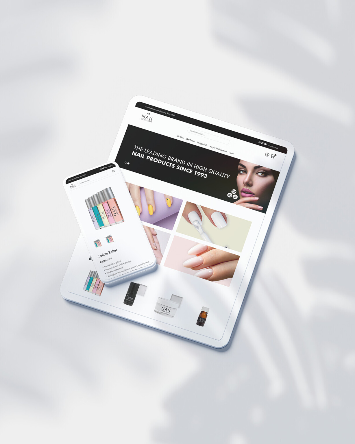 Tablet en smartphone met een website met Nail Creation-producten, waarop verschillende nagellakken, gereedschappen en manicure-gerelateerde artikelen worden getoond.