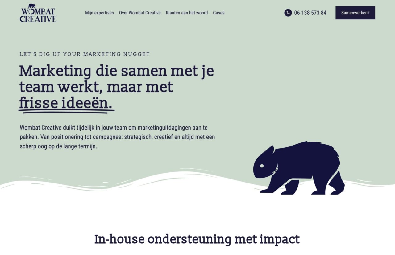 Websiteheader voor Wombat Creative met marketingtekst en een silhouet van een wombat op een lichtgroene achtergrond.